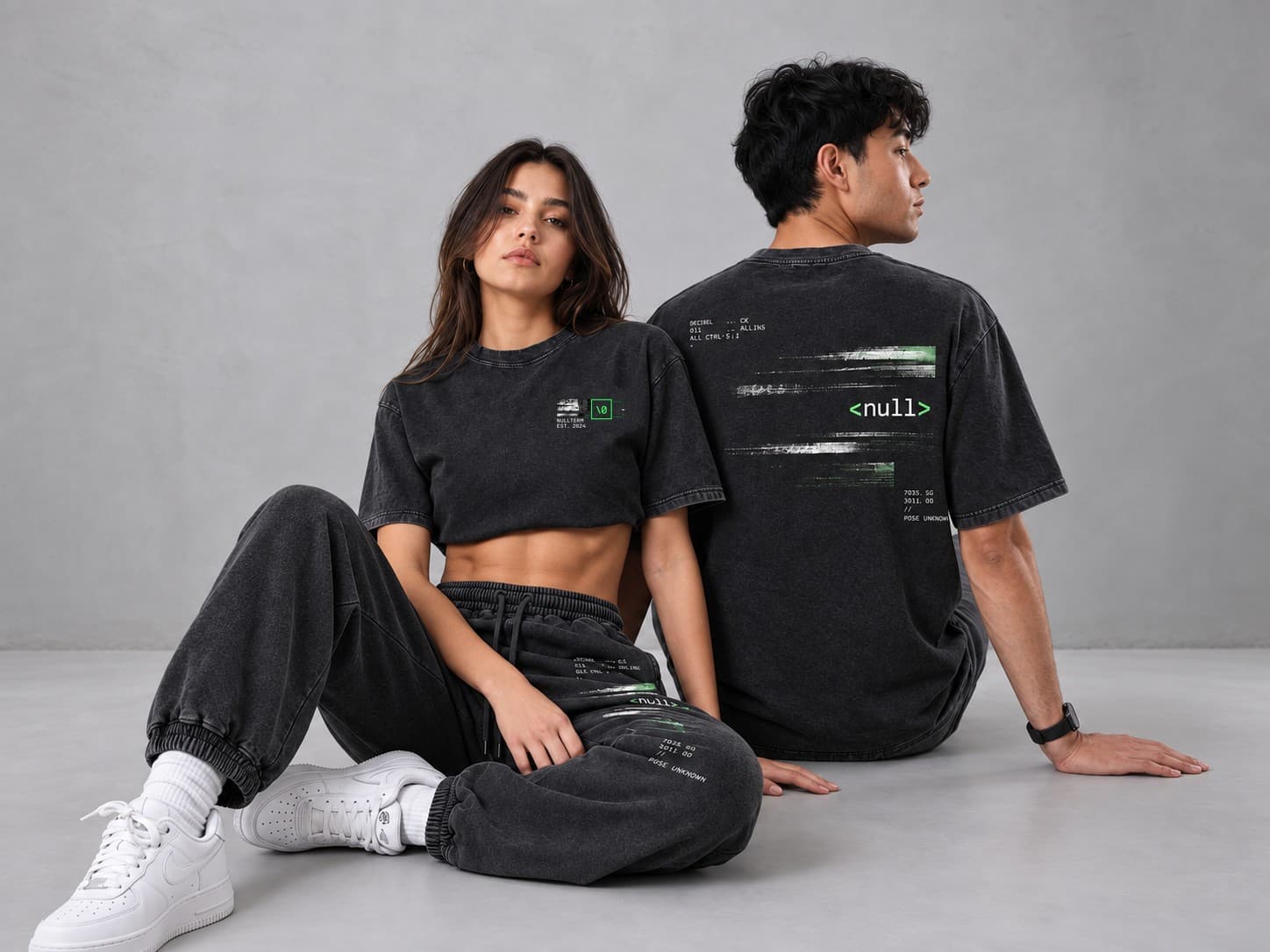 Two models in washed-black NULLTERM tees and sweatpants; the back print reads <null>.